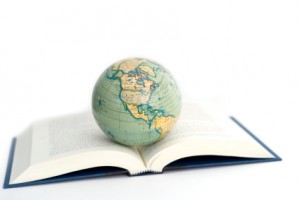 world globe on a open book on white background